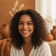 Close-up portrait of a smiling young woman, conveying trust and happiness.